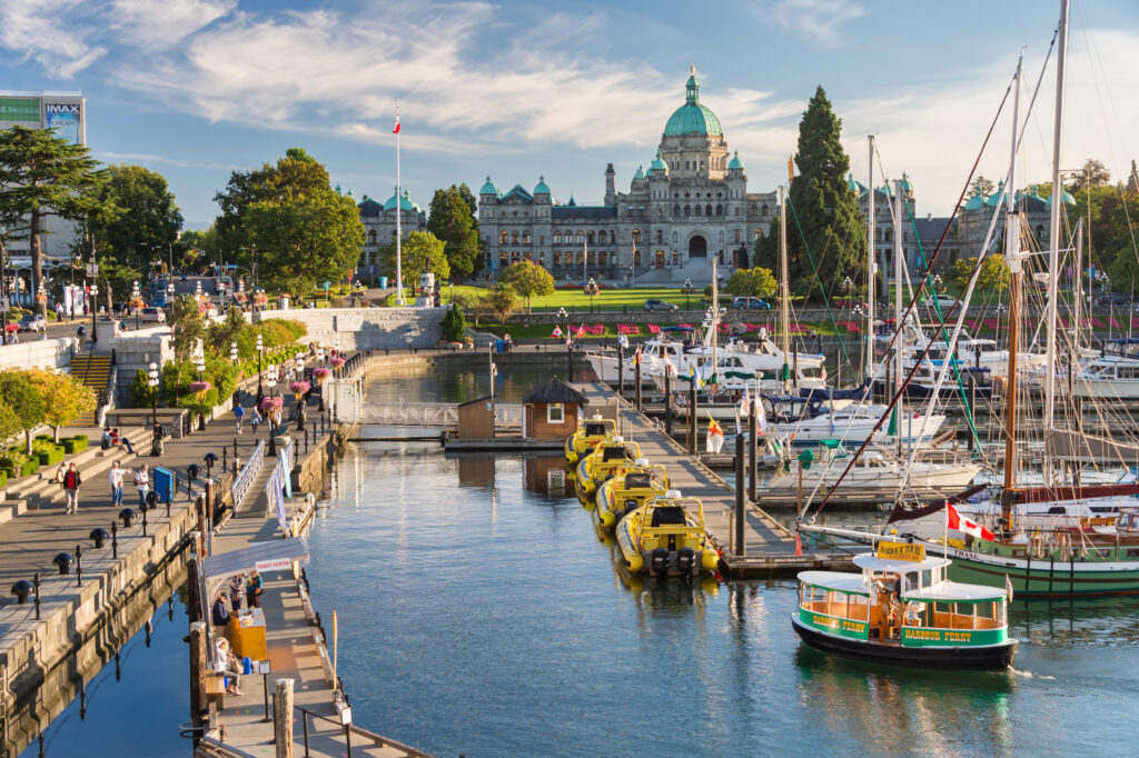 The sights at Fisherman's Wharf in Victoria BC. People on vacation sightseeing and eating at restaurants.