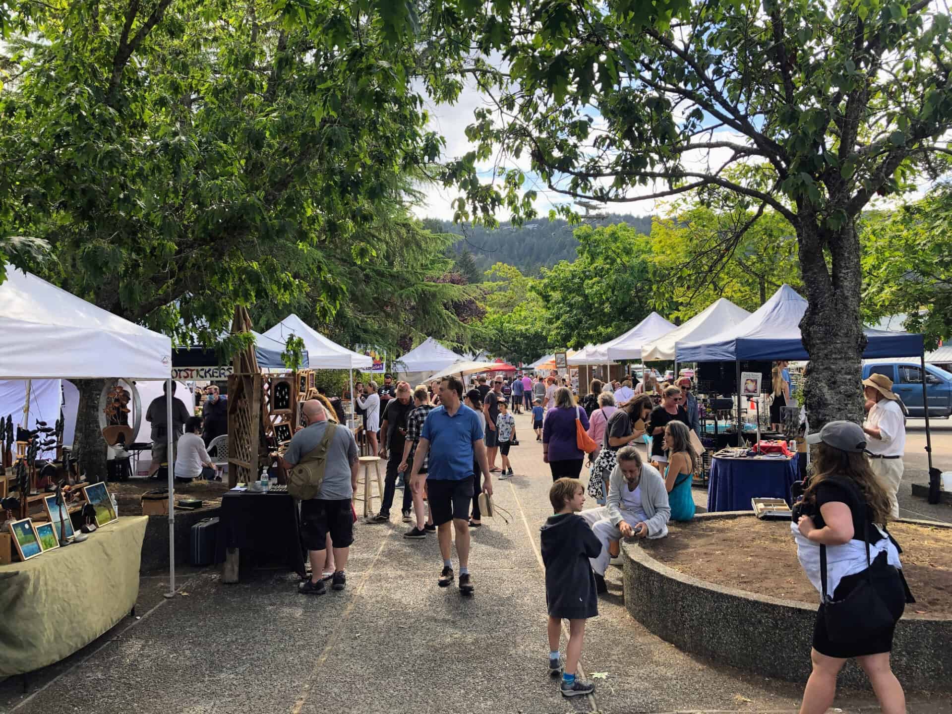 Ganges, British Columbia, Canada - August 27th, 2022: A crowd of people enjoying the saturday afternoon street market on a beautiful summer day in Ganges, Saltspring Island, Canada